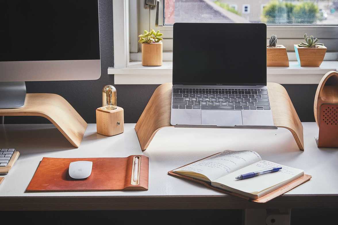 Office desk setup with documents, laptop, and calculator used for small business tax preparation.